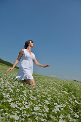 Image showing Young happy woman in green field