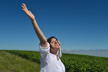 Image showing Young happy woman in green field