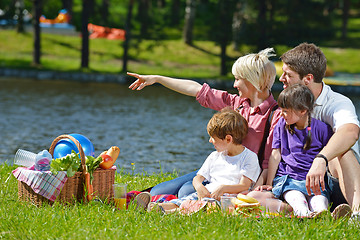 Image showing Happy family playing together in a picnic outdoors