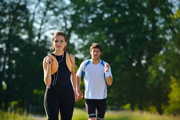 Image showing Young couple jogging