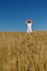 Image showing young woman in wheat field at summer