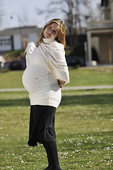 Image showing happy young pregnant woman outdoor