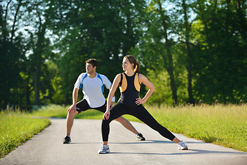 Image showing Couple doing stretching exercise  after jogging