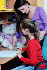 Image showing mom and girl doing homework at home
