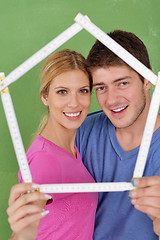 Image showing happy couple paint wall at new home