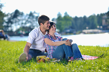 Image showing happy young couple having a picnic outdoor