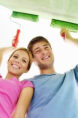 Image showing happy couple paint wall at new home