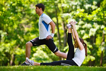 Image showing Couple doing stretching exercise  after jogging