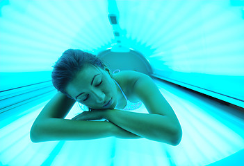 Image showing Beautiful young woman tanning in solarium