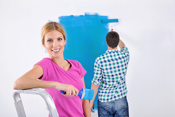 Image showing happy couple paint wall at new home