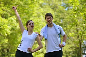 Image showing Couple doing stretching exercise  after jogging