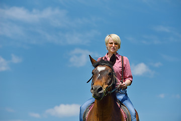 Image showing happy woman  ride  horse