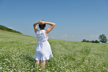 Image showing Young happy woman in green field