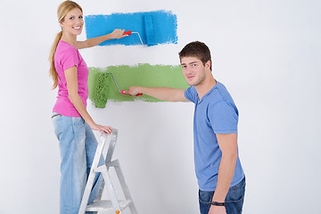 Image showing happy couple paint wall at new home