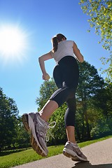 Image showing Young beautiful  woman jogging at morning in park