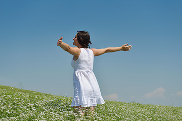 Image showing Young happy woman in green field