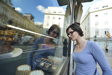 Image showing woman in front of sweet store window