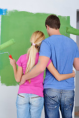 Image showing happy couple paint wall at new home