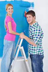 Image showing happy couple paint wall at new home