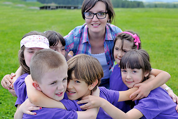 Image showing happy kids group with teacher in nature