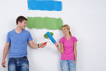 Image showing happy couple paint wall at new home