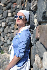 Image showing Greek woman on the streets of Oia, Santorini, Greece