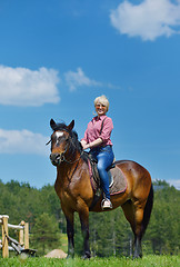 Image showing happy woman  ride  horse