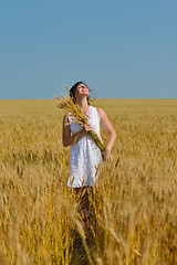 Image showing young woman in wheat field at summer