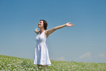 Image showing Young happy woman in green field