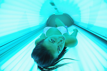 Image showing Beautiful young woman tanning in solarium