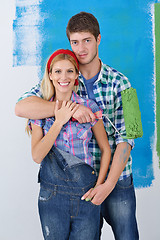 Image showing happy couple paint wall at new home