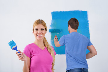 Image showing happy couple paint wall at new home