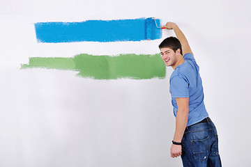 Image showing happy couple paint wall at new home