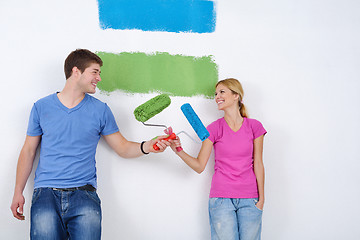 Image showing happy couple paint wall at new home