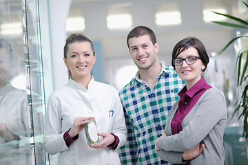 Image showing pharmacist suggesting medical drug to buyer in pharmacy drugstor