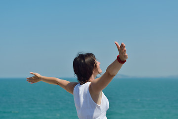 Image showing happy young woman with spreading arms to sky