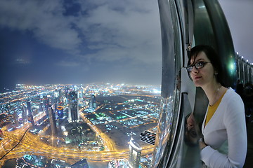 Image showing beautiful woman portrait with big city at night in background