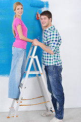 Image showing happy couple paint wall at new home