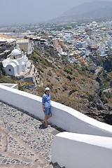 Image showing Greek woman on the streets of Oia, Santorini, Greece