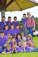 Image showing happy kids group with teacher in nature