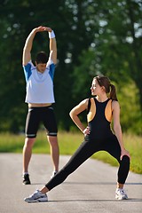 Image showing Couple doing stretching exercise  after jogging