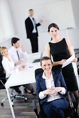 Image showing business woman with her staff in background