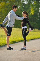 Image showing Couple doing stretching exercise  after jogging