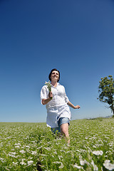 Image showing Young happy woman in green field