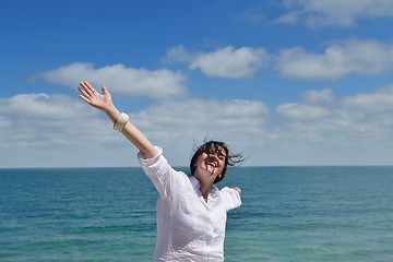 Image showing happy young woman with spreading arms to sky