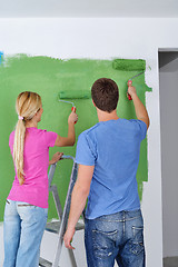 Image showing happy couple paint wall at new home