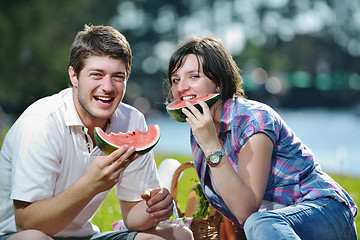 Image showing happy young couple having a picnic outdoor