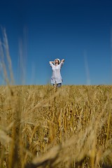 Image showing young woman in wheat field at summer