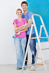 Image showing happy couple paint wall at new home