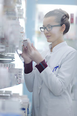 Image showing pharmacist chemist woman standing in pharmacy drugstore